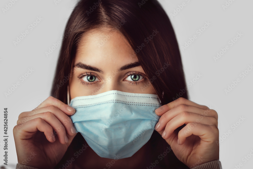 Young woman studio portrait while wearing face mask Young woman studio portrait while wearing face mask