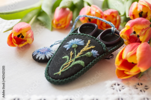 hand-embroidered case for scissors on a natural background