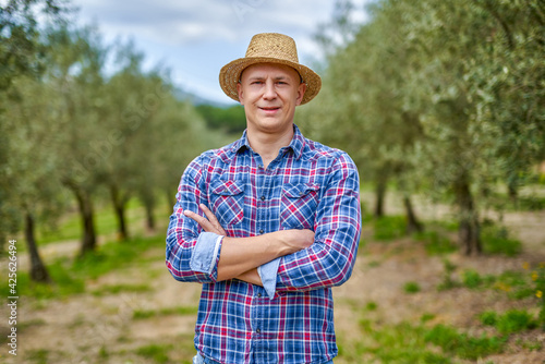 Canvas Print Olive grower working in olive grove.