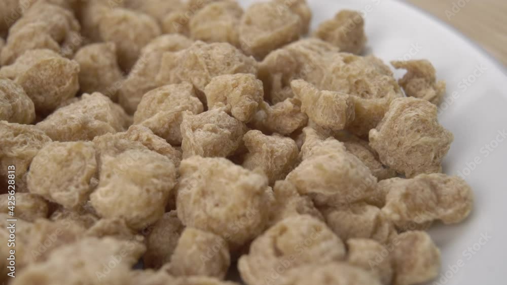 Uncooked dried soybeans close-up in a white bowl. Macro. Dolly Shot. Vegetable meat substitute Uncooked dried soybeans close-up in a white bowl. Macro. Dolly Shot. Vegetable meat substitute