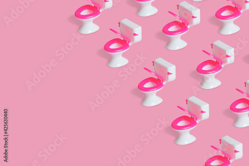 Simple pattern with a toilet bowl on a pink background.