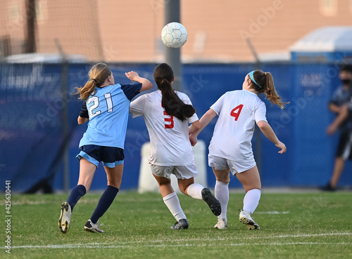 Young athletic girl making an amazing play during a soccer match