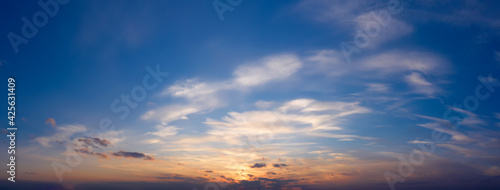 Beautiful sunset sky with clouds. Panorama of dramatic sky during golden hour.