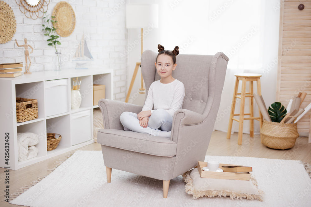 cute preteen girl sitting in bright living room cute preteen girl sitting in bright living room