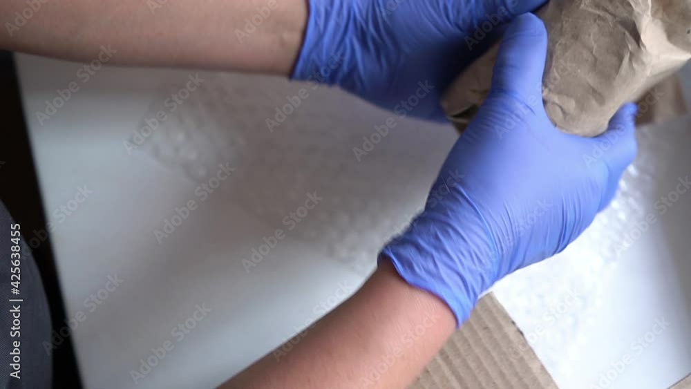 Woman is packaging beauty products into a box. Delivery of cosmetics Woman is packaging beauty products into a box. Delivery of cosmetics