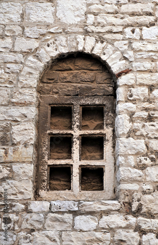 Decorative antique stone window built into the stone wall