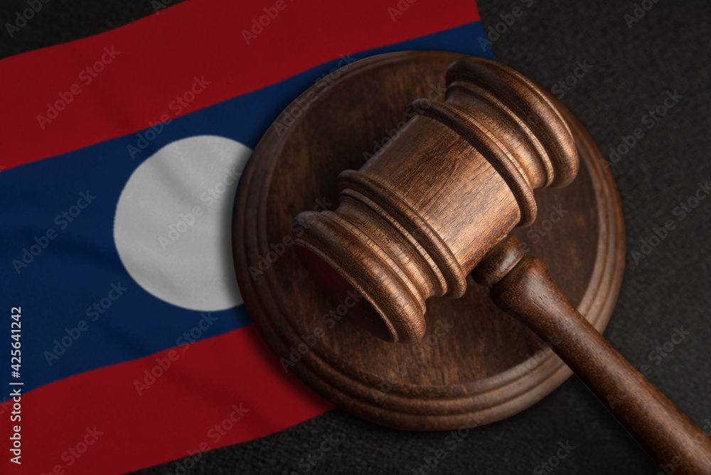 Judge gavel and flag of Laos. Law and justice in Laos. Violation of rights and freedoms