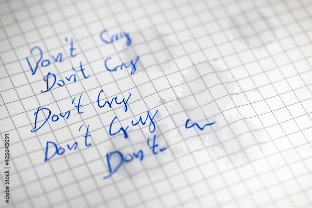 Tears on white paper with do not cry text Tears on white paper with do not cry text