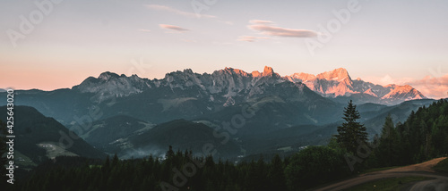 Beautiful atmospheric red morning lights between the mountain tops of the austrian dolomites