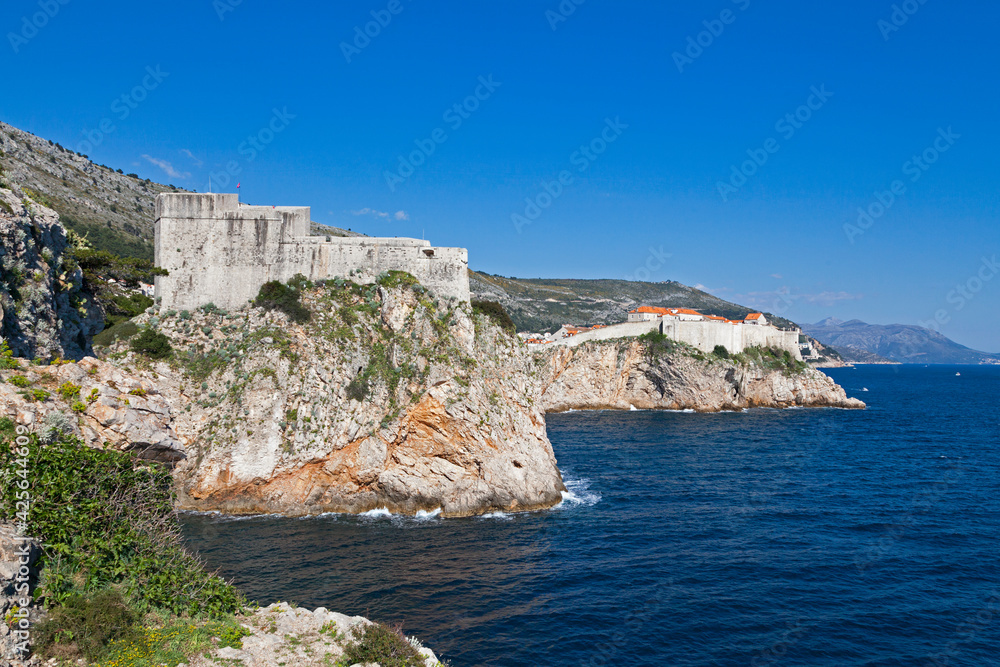 The Fort Lovrijenac and the walls of Dubrovnik on top of a cliff overlooking the Adriatic Sea.