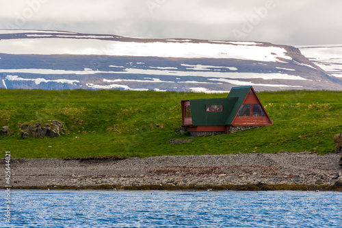 isolated wooden house on Vigur island, on the north western coast of Iceland during summer season photo