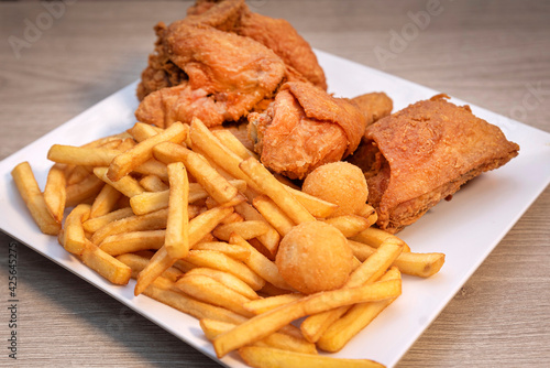 chicken and french fries on a white plate