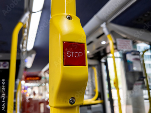 focus on a red 'Stop' button inside a metro bus in Seattle, WA