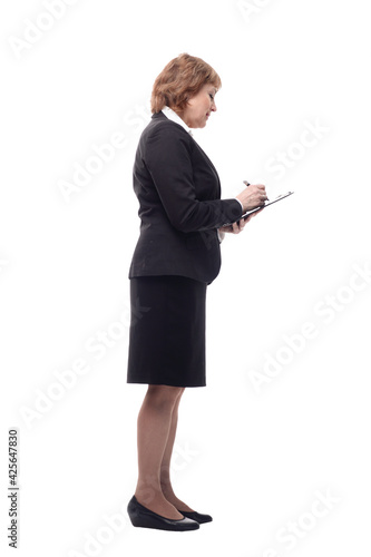 Side view of senior stylish businesswoman writing on clipboard