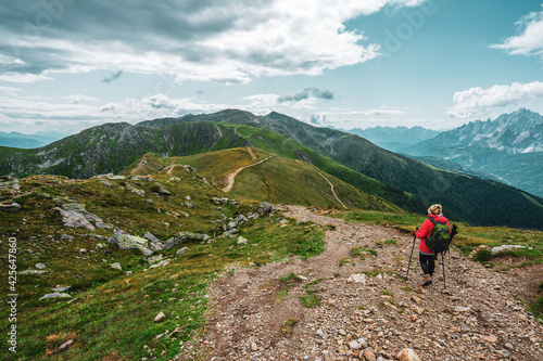 Backpacker on hiking trails in the Dolomites, Italy.