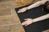 girl's hands on yoga mat