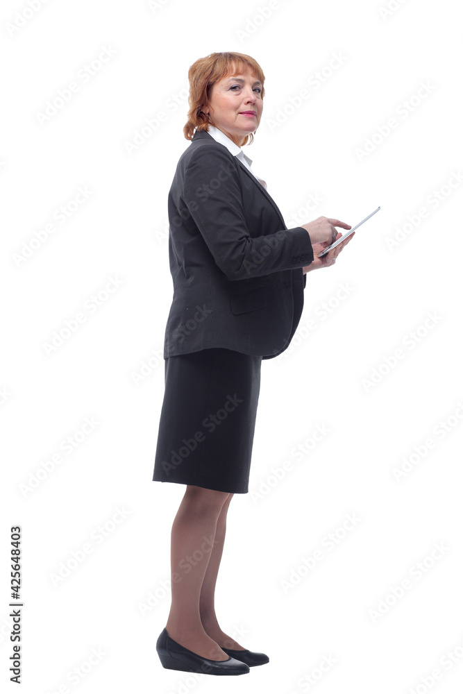 Profile view of aged woman holding tablet and looking at screen with satisfied face Profile view of aged woman holding tablet and looking at screen with satisfied face