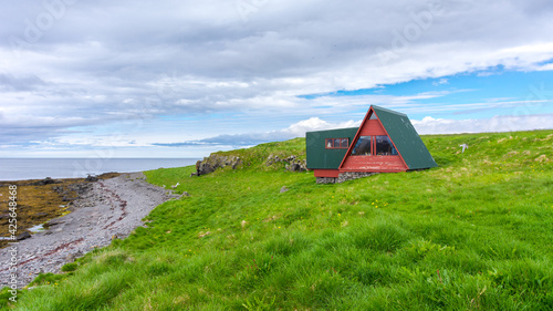 isolated wooden house on Vigur island, on the north western coast of Iceland during summer season photo