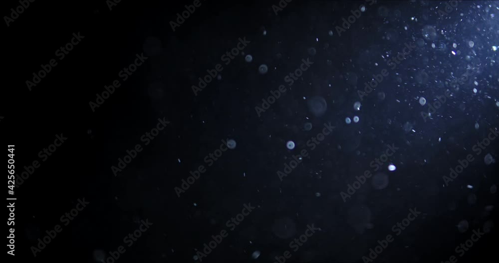 Shot of real dust particles floating in the air. Dust Particles Background. Macro slow motion shot, Use blending mode (screen) Shot of real dust particles floating in the air. Dust Particles Background. Macro slow motion shot, Use blending mode (screen)