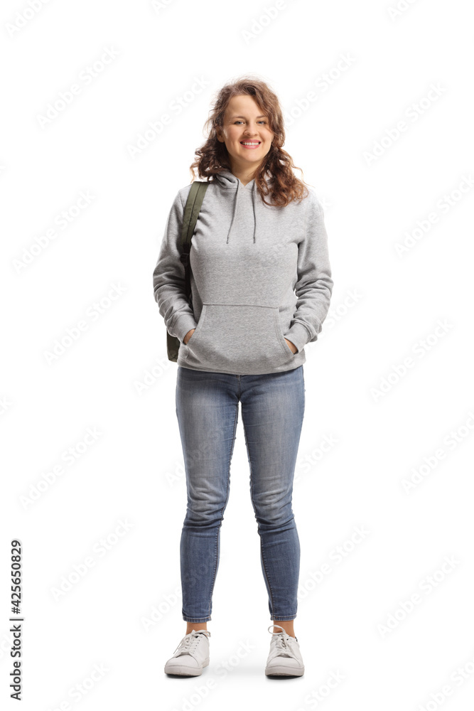 Full length portrait of a female student standing and smiling at the camera - obrazy, fototapety, plakaty 