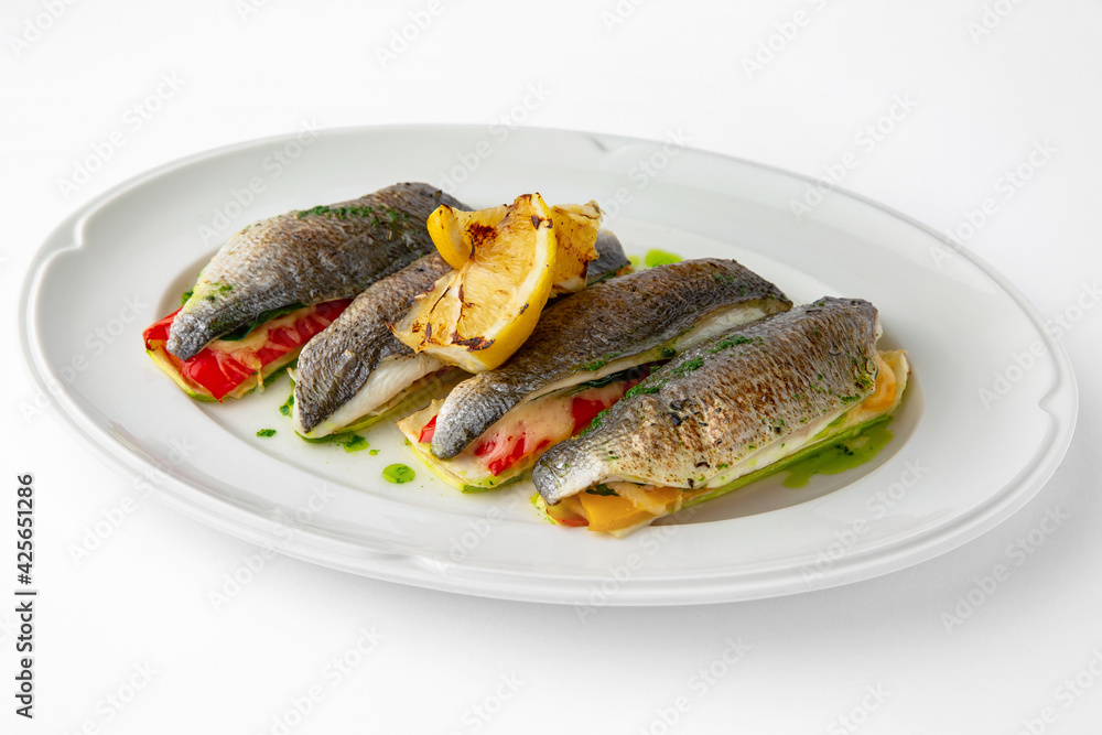 Dorada stuffed with vegetables, baked in the oven with cheese. Banquet festive dishes. Gourmet restaurant menu. White background. 