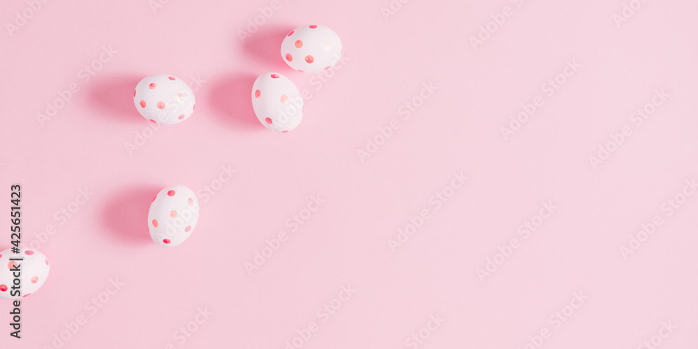 Easter pink composition. Easter eggs on pastel pink background. Minimal concept of Easter. Flat lay, top view, copy space. 