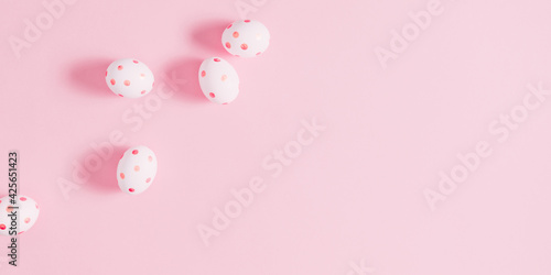Easter pink composition. Easter eggs on pastel pink background. Minimal concept of Easter. Flat lay, top view, copy space.  © prime1001