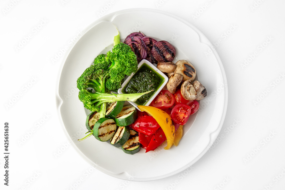 Appetizer of grilled vegetables from zucchini, eggplants, tomatoes, sweet peppers, onions. Rolls stuffed with cheese. Banquet festive dishes. Gourmet restaurant menu. White background. Appetizer of grilled vegetables from zucchini, eggplants, tomatoes, sweet peppers, onions. Rolls stuffed with cheese. Banquet festive dishes. Gourmet restaurant menu. White background.