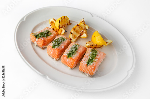 Large pieces of fillet baked with salmon cheese and sauce. Banquet festive dishes. Gourmet restaurant menu. White background.
