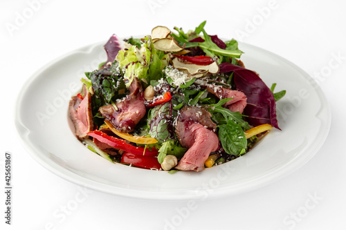 Salad with beef, vegetables and herbs. Banquet festive dishes. Gourmet restaurant menu. White background.