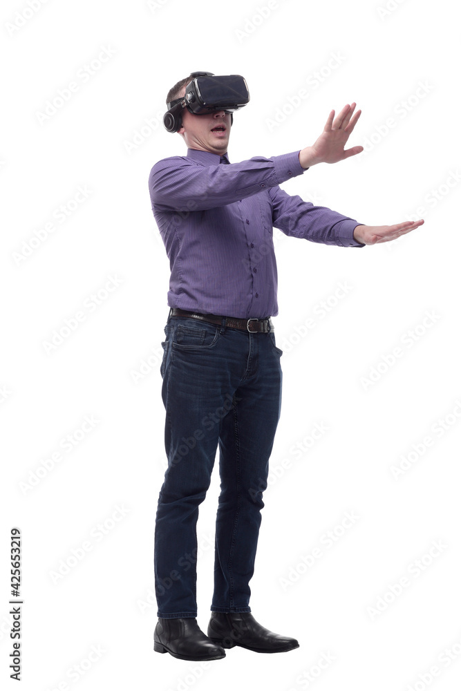 Excited man experiencing virtual reality via VR headset and touching something with his hands Excited man experiencing virtual reality via VR headset and touching something with his hands