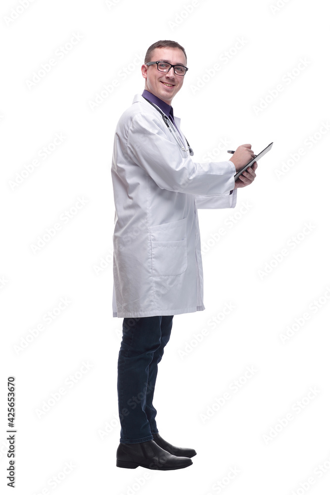 Side view of concentrated male doctor writing reports Side view of concentrated male doctor writing reports