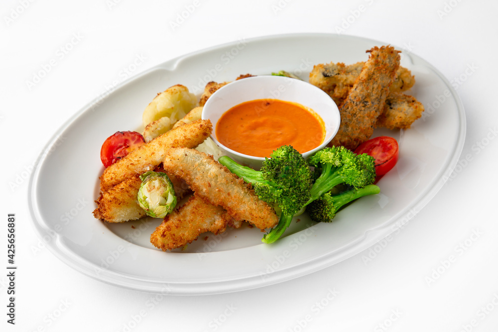 Fish fillets, chicken in batter with vegetables. Banquet festive dishes. Gourmet restaurant menu. White background.