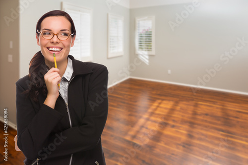 Woman With Pencil In Empty Room of New House photo