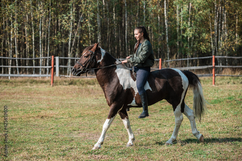 Horse ride of a young girl in places with beautiful autumn countryside landscapes