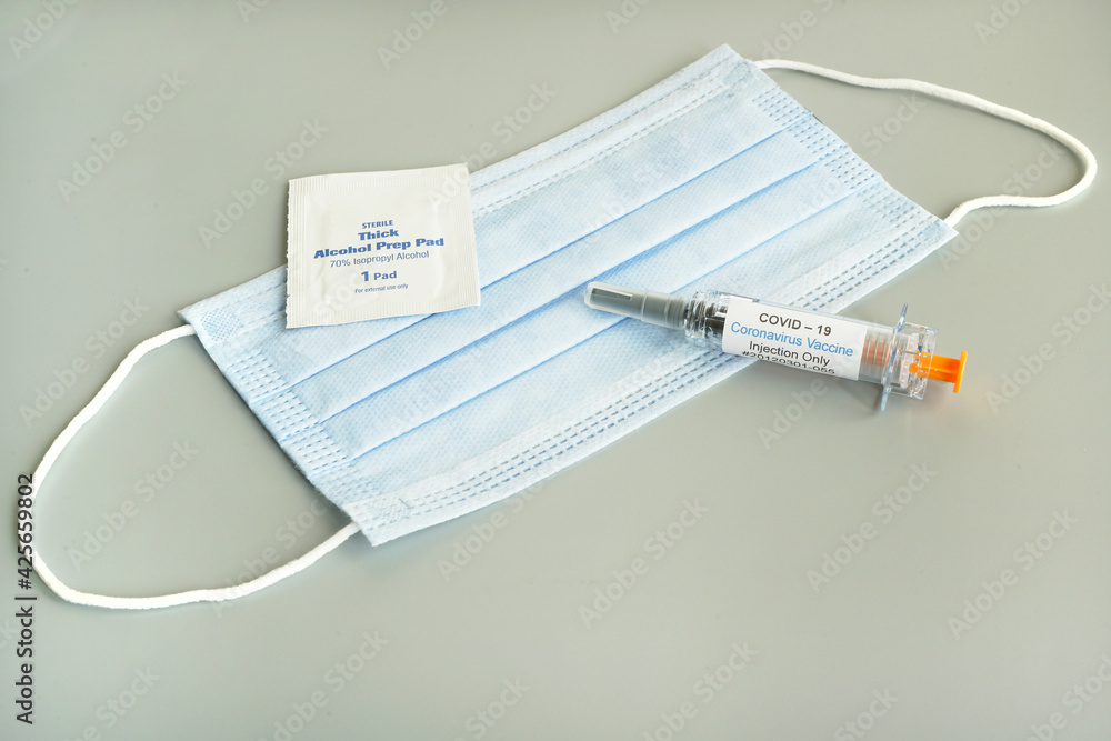 Coronavirus vaccine syringe concept and syringe injection wit mask . Vaccine Concept of fight against coronavirus. Coronavirus vaccine syringe concept and syringe injection wit mask . Vaccine Concept of fight against coronavirus.