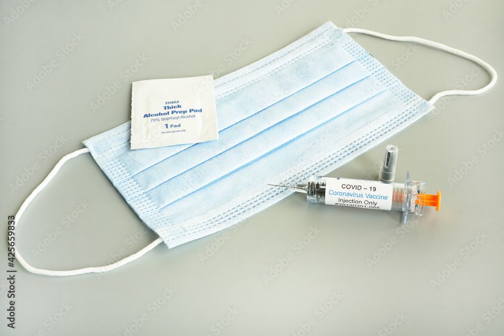 Coronavirus vaccine syringe concept and syringe injection wit mask . Vaccine Concept of fight against coronavirus. Coronavirus vaccine syringe concept and syringe injection wit mask . Vaccine Concept of fight against coronavirus.
