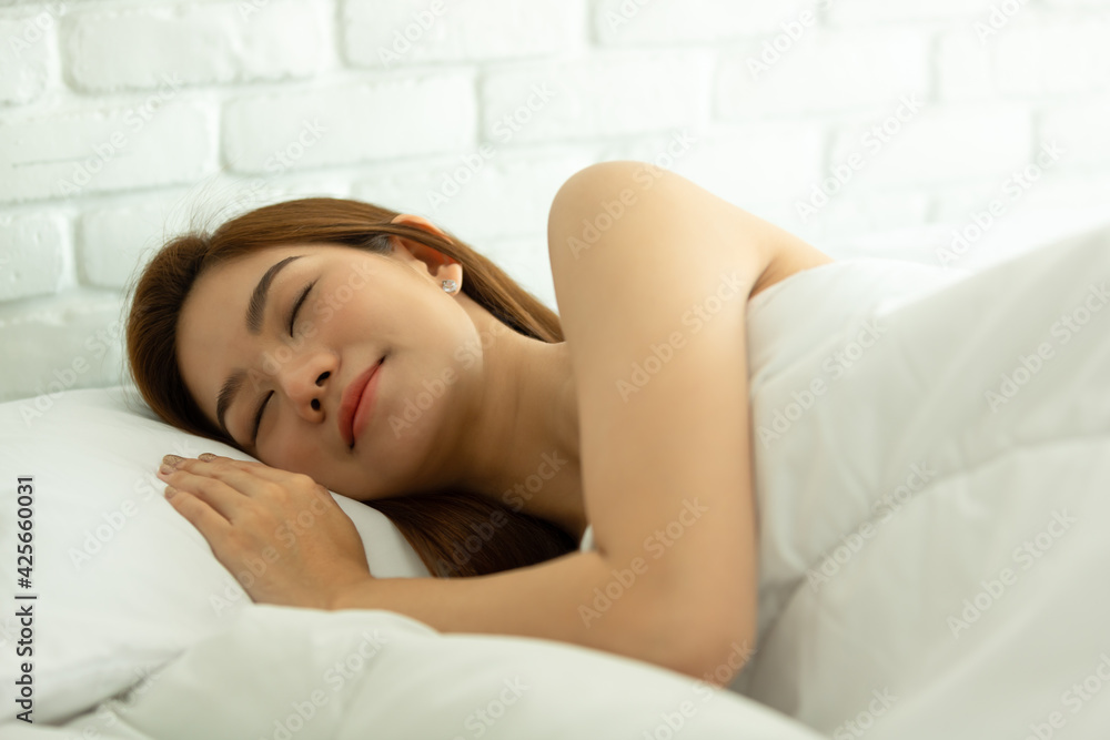 Asian women sleeping and sweet dream on white bed in bedroom Asian women sleeping and sweet dream on white bed in bedroom
