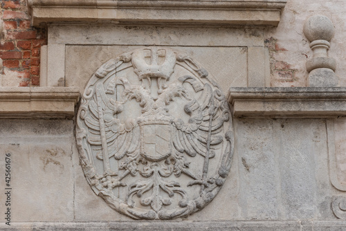 Old coat of arms on a house in the city of Brno. Bas-relief in the form of a two-headed eagle in the Czech city