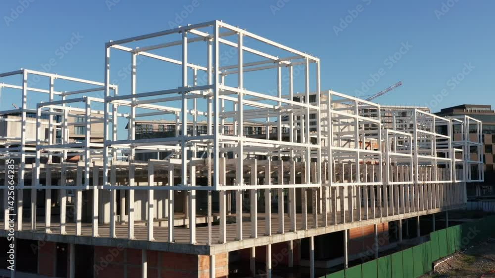 Construction site of modern architecture office or commercial building made of steel reinforced concrete. Drone footage. Construction site of modern architecture office or commercial building made of steel reinforced concrete. Drone footage.