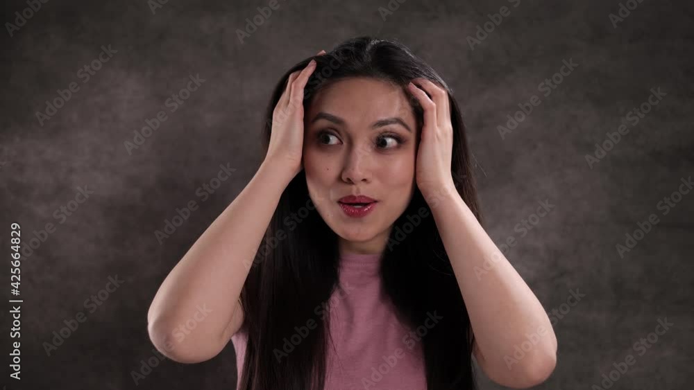 Young woman is acting very surpised - studio shooting Young woman is acting very surpised - studio shooting