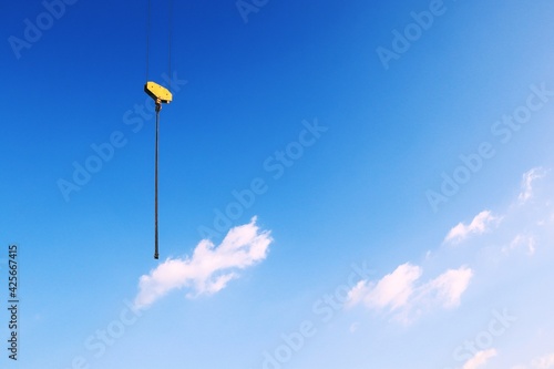 Chain hoist, tower crane components and blue sky background.