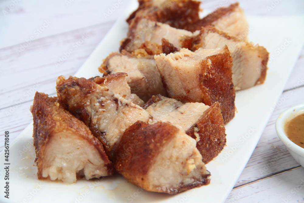 Freshly cooked Filipino food called Lechon Kawali or pan fried chopped crispy pork belly Freshly cooked Filipino food called Lechon Kawali or pan fried chopped crispy pork belly