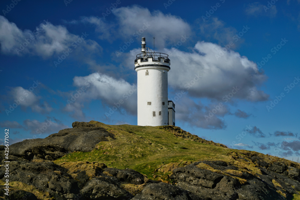 Elie light house with blue sky and cloud formations, located in Fife, Scotland.