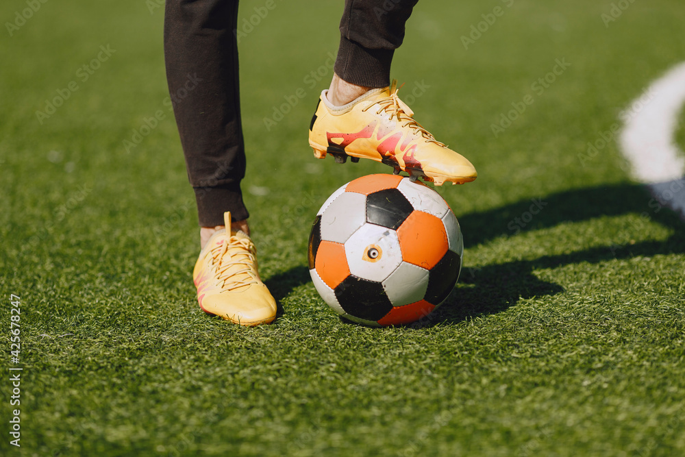 Obraz premium Sporman is playing football and practising with the ball