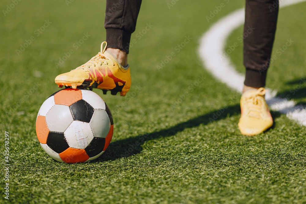Obraz premium Sporman is playing football and practising with the ball