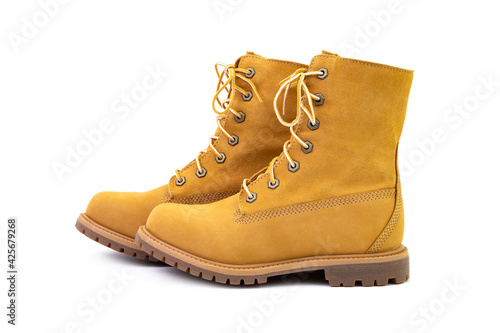 Pair of short yellow suede boots isolated on white background. Fashion and shopping concept