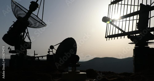 Space radar antenna on sunset. Silhouettes of satellite dishes or radio antennas against night sky. Creative artwork decoration. Selective focus