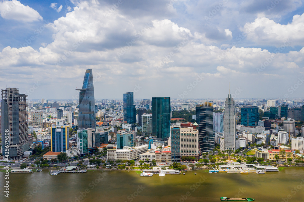 Fototapeta premium Aerial cityscape of Ho Chi Minh city along Saigon river