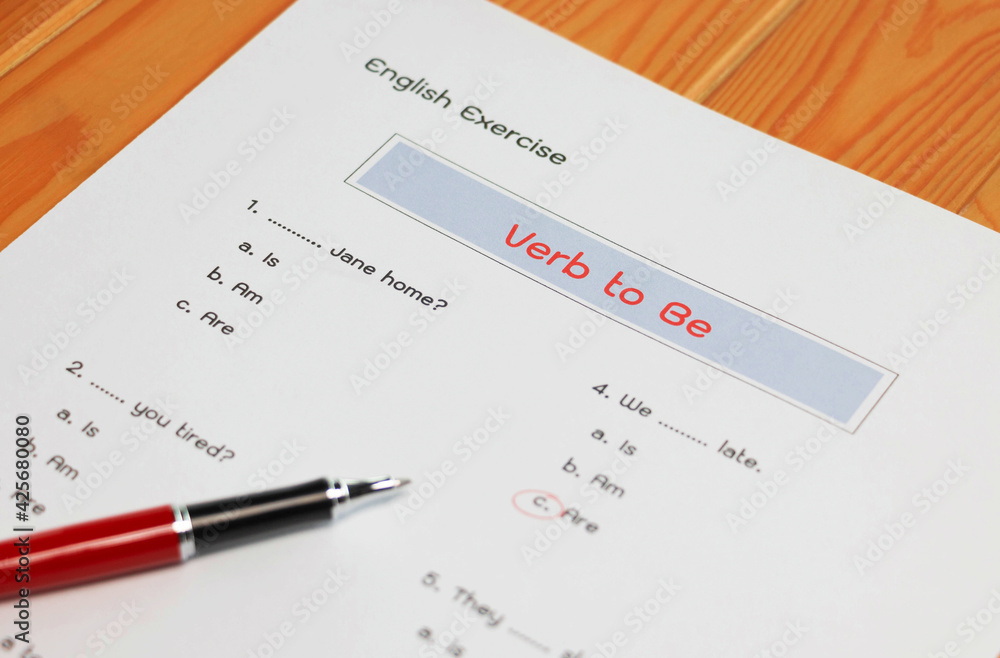 English grammar test sheet on wooden table English grammar test sheet on wooden table